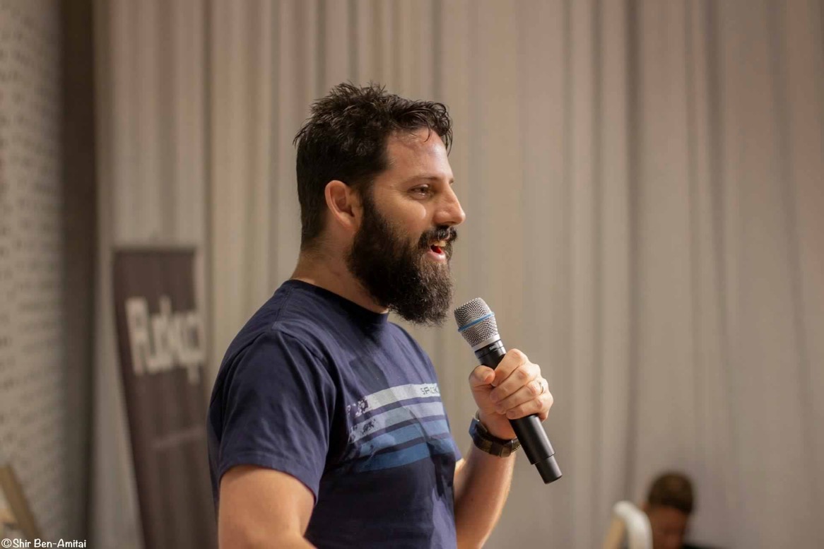 Adam Tal at a microphone